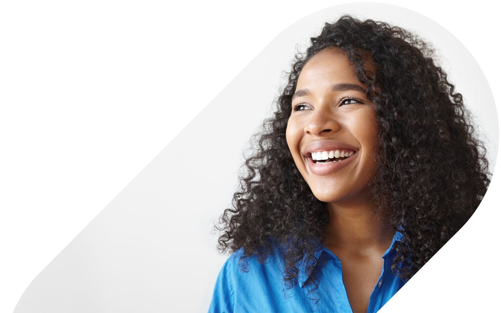 A smiling woman with curly hair looking off to the side framed in a colored oval