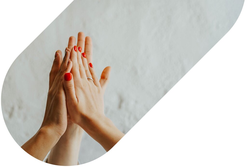 Two people holding hands with their palms pressed together
