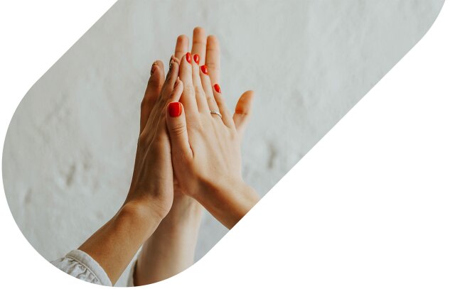 Two people holding hands with their palms pressed together